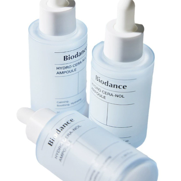 Eco‑friendly glass bottle next to recycled paper packaging highlighting sustainable brand values.