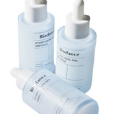 Eco‑friendly glass bottle next to recycled paper packaging highlighting sustainable brand values.