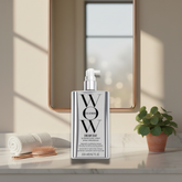 Dream Coat Hair Spray bottle showcasing smooth shine finish on glossy hair.